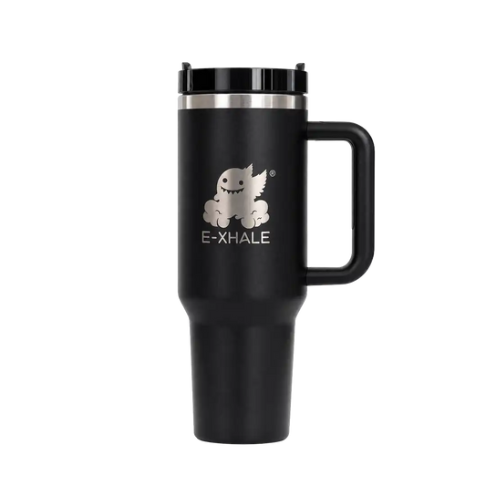 A matte black insulated travel tumbler with a handle, black lid, and a silver graphic of a cartoon creature above the text 'E-XHALE' on the front, shown on a plain white background.