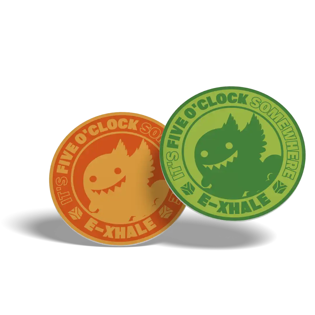 Two circular enamel pins with the text 'IT'S FIVE O'CLOCK SOMEWHERE E-XHALE' and a cartoon creature, shown in orange and green on a white background.