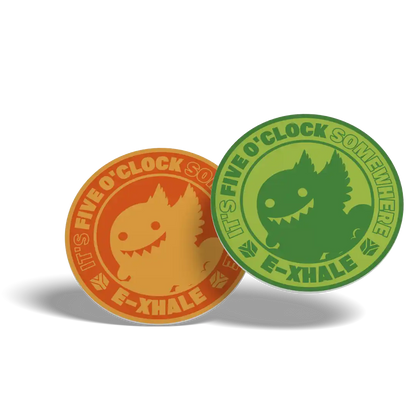 Two circular enamel pins with the text 'IT'S FIVE O'CLOCK SOMEWHERE E-XHALE' and a cartoon creature, shown in orange and green on a white background.