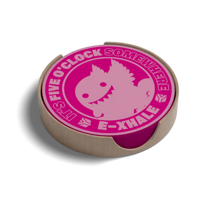 A round wooden coaster with a bright pink printed design featuring a cartoon fish and the text 'IT'S FIVE O'CLOCK SOMEWHERE' and 'E-XHALE', shown on a white background with a soft shadow.